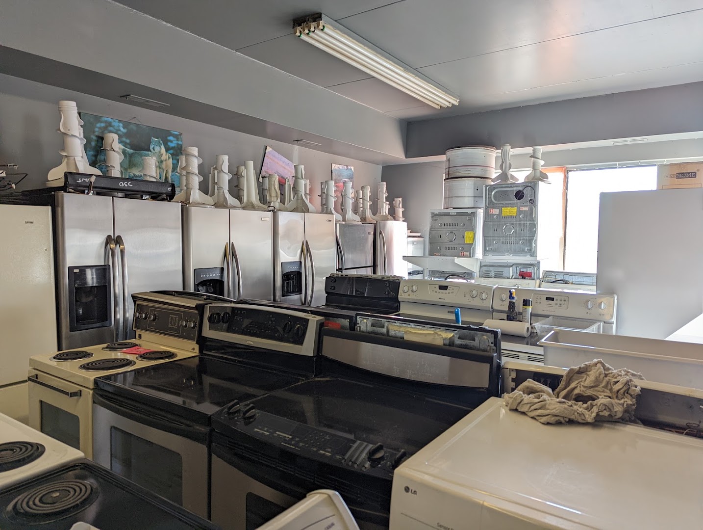 Showroom of stainless steel fridges and stoves at Moe's
