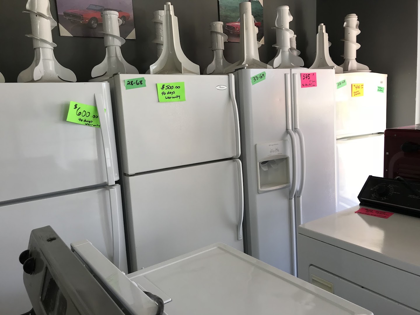 Tagged refurbished fridges with 90-day warranty labels