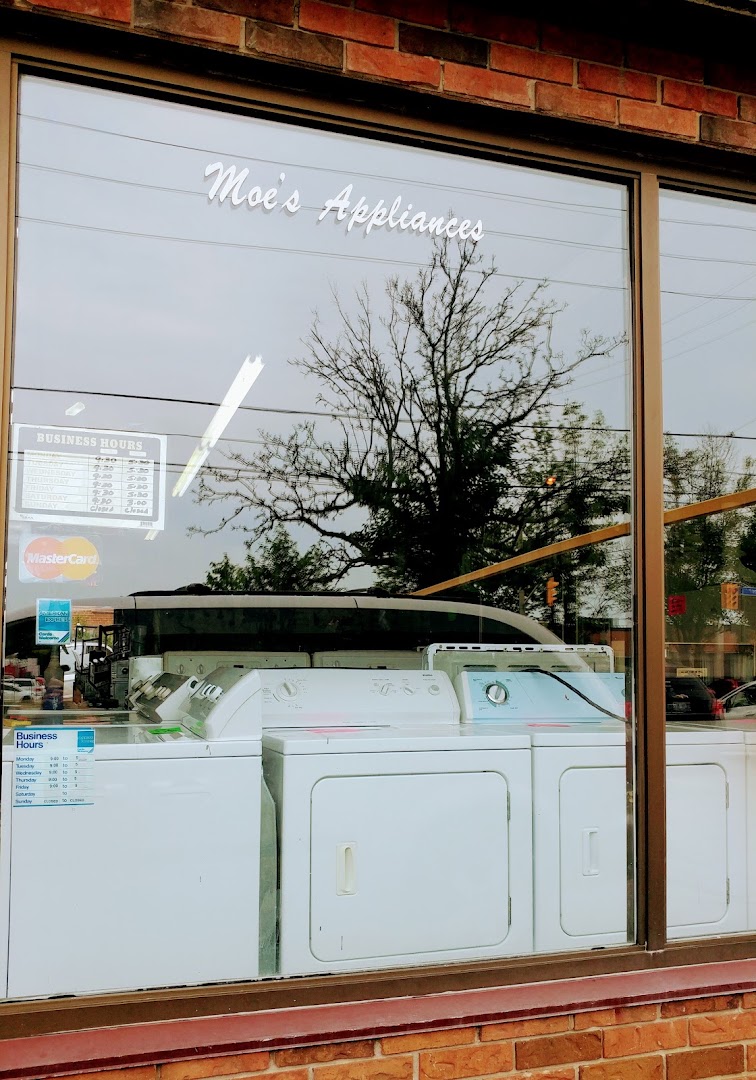 Moe's Appliances window lettering with washers on display